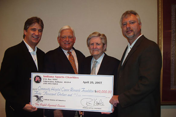 (From left) Brian Popp, Indiana Sports Charities board member; John Mybeck, senior vice president and chief administrative officer of Community Foundation of Northwest Indiana; Donald S. Powers, chairman, president and chief executive officer of Community Foundation of Northwest Indiana; and Ron Kittle, chairman of Indiana Sports Charities, hold a giant check representing a giant donation of $40,000 to Community Cancer Research Foundation from Indiana Sports Charities.